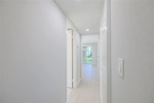 a view of hallway with bathroom