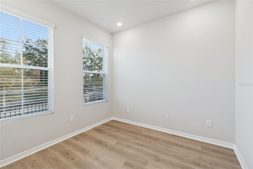 4317 Roush Avenue Orlando, FL 32803 - Photo 12 of 39 a view of an empty room with wooden floor and a window