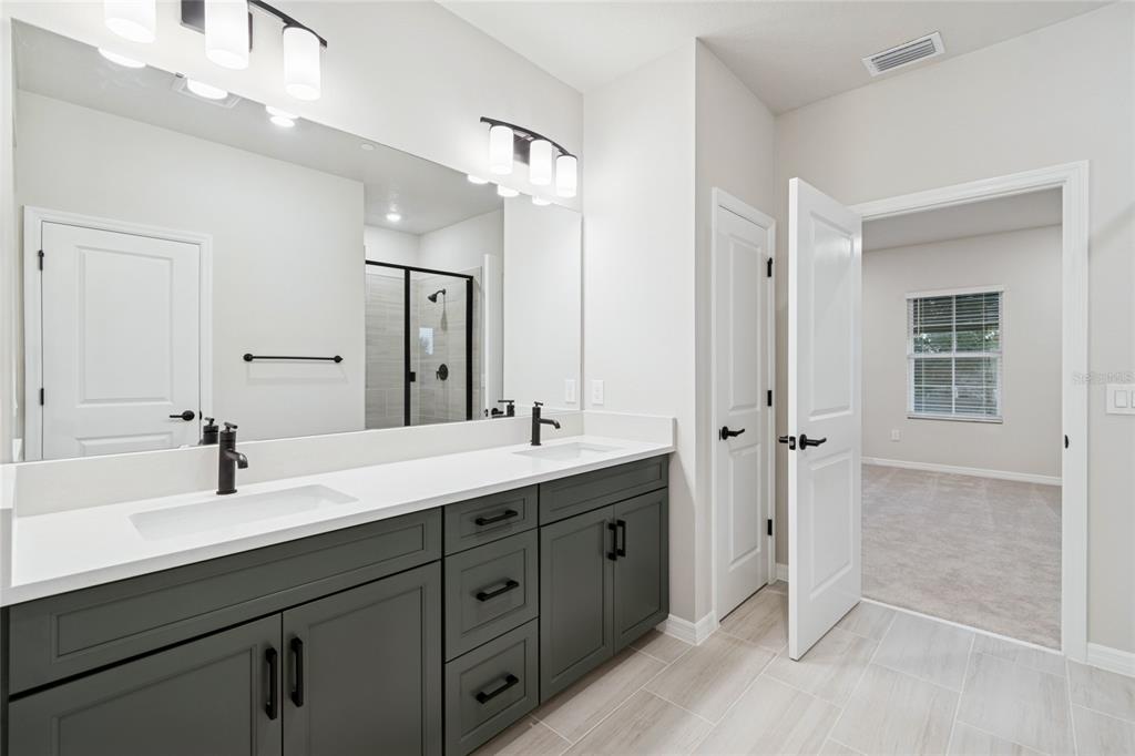 4317 Roush Avenue Orlando, FL 32803 - Photo 22 of 39 a spacious bathroom with a double vanity sink mirror and double