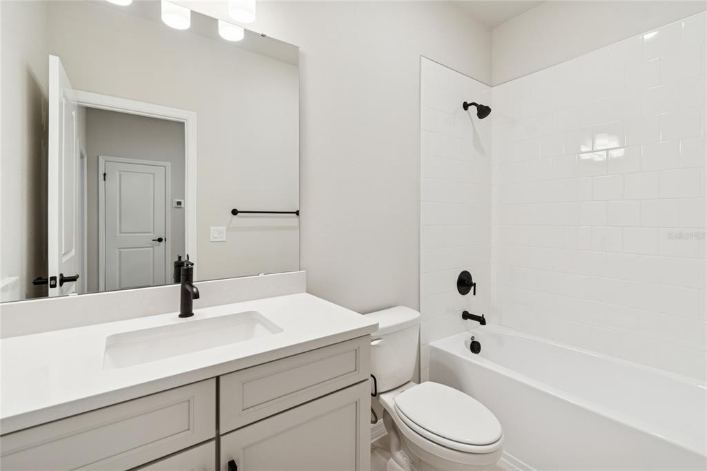 4317 Roush Avenue Orlando, FL 32803 - Photo 27 of 39 a bathroom with a sink a toilet and shower