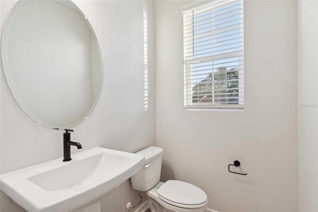 4317 Roush Avenue Orlando, FL 32803 - Photo 30 of 39 a bathroom with a toilet a sink and mirror