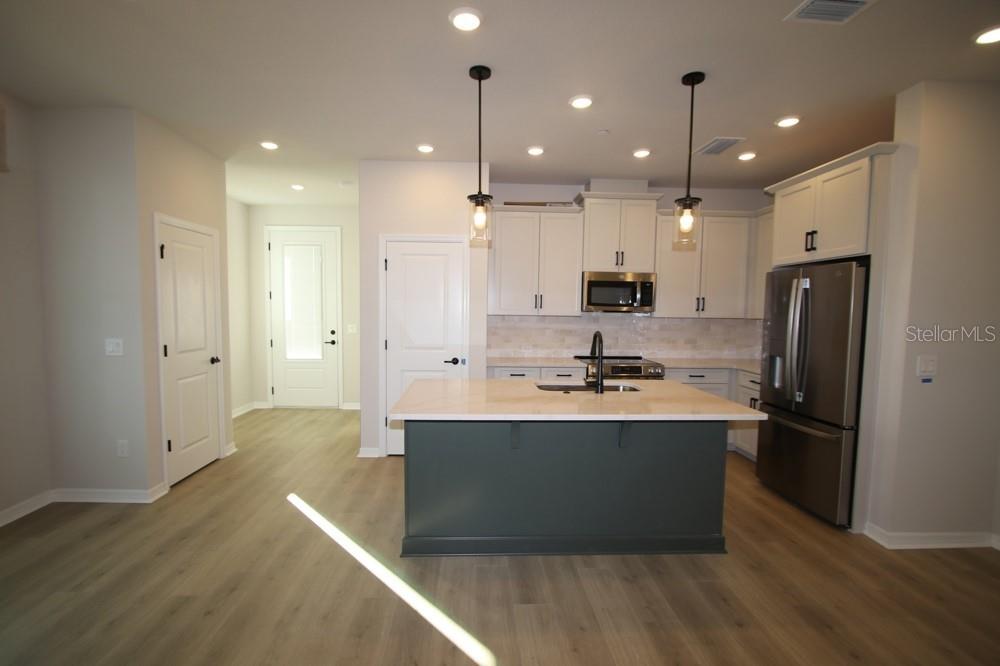 4317 Roush Avenue Orlando, FL 32803 - Photo 6 of 13 a kitchen with stainless steel appliances granite countertop a sink and a refrigerator