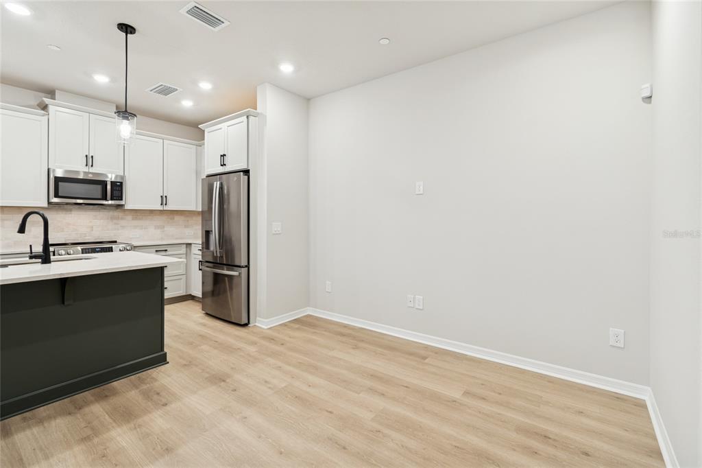 4317 Roush Avenue Orlando, FL 32803 - Photo 8 of 39 a kitchen with stainless steel appliances a refrigerator sink and microwave