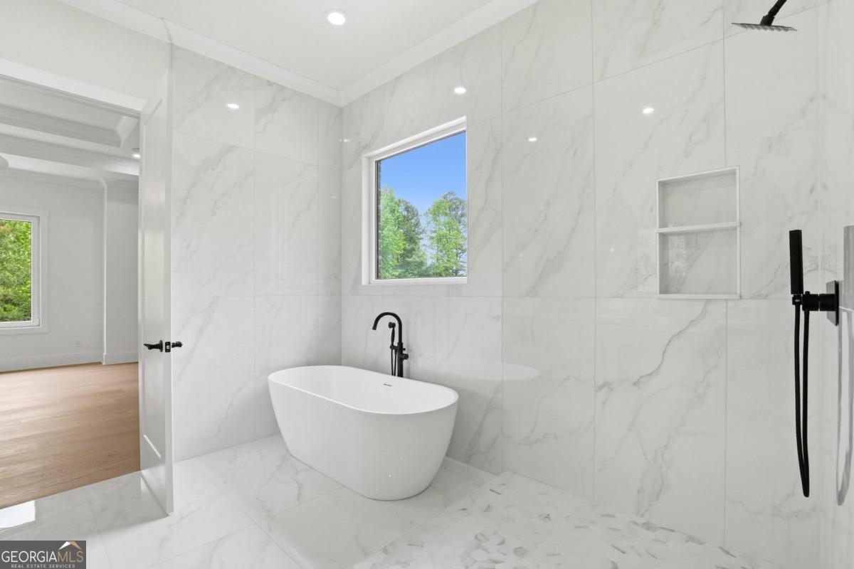 1557 Whitley Road Dacula, GA 30019 - Photo 20 of 46 a bathroom with a white tub shower and sink