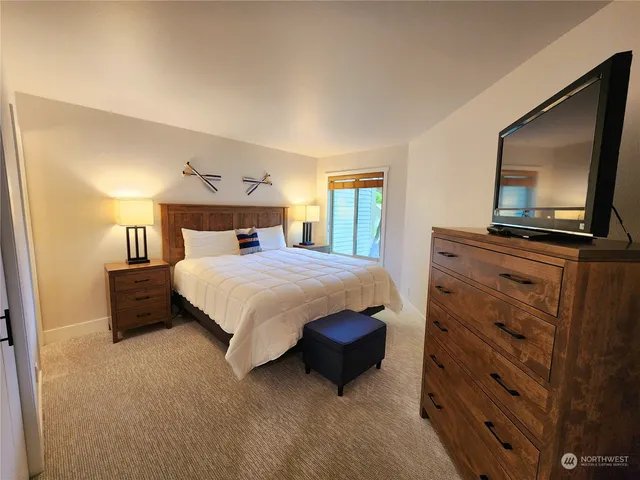 a bedroom with a bed and a flat screen television