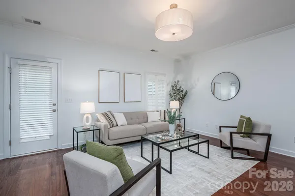 a living room with furniture a rug and a window