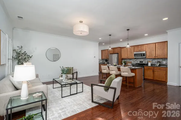 a living room with kitchen furniture kitchen and a dining table