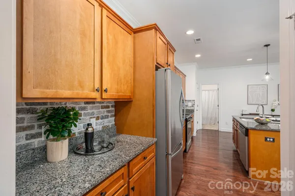 a kitchen with stainless steel appliances granite countertop sink stove and refrigerator