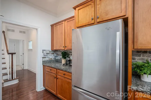 a kitchen with stainless steel appliances a refrigerator and a stove