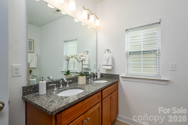 a bathroom with sinks granite countertop a sink and a mirror