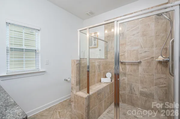 a bathroom with a glass shower door