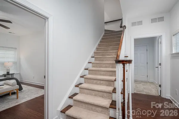 a view of entryway and hall with wooden floor