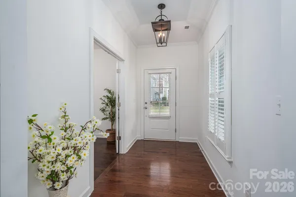 a view of hallway with wooden floor