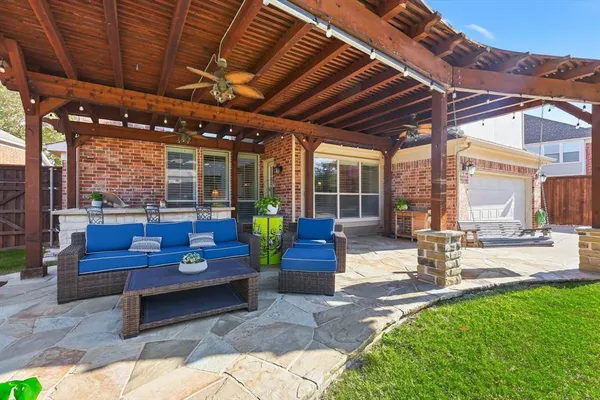 a building outdoor space with patio furniture and potted plants