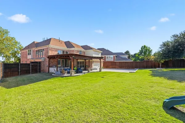 a view of a house with a big yard and sitting area