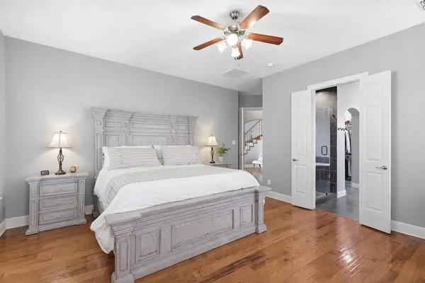 a spacious bedroom with a bed and a chandelier