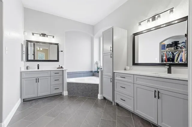 a en suite bathroom with a sink a toilet and a mirror