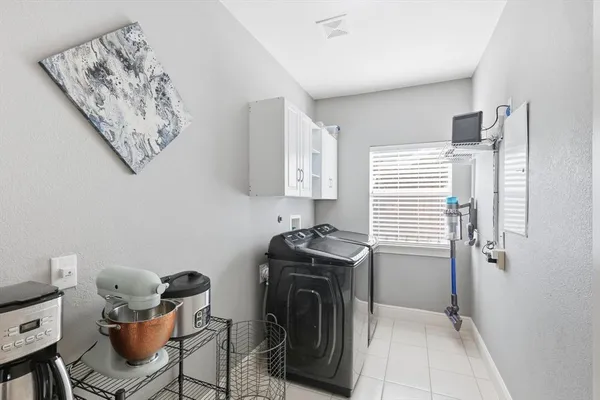 a utility room with cabinets and a window