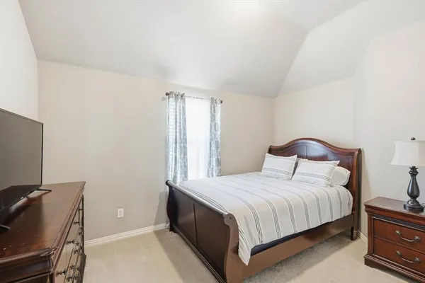 a bedroom with a bed and a chair