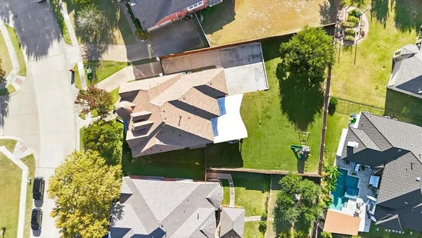 an aerial view of a house with a yard and lake view