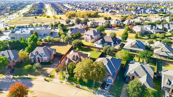 an aerial view of residential houses with outdoor space and swimming pool