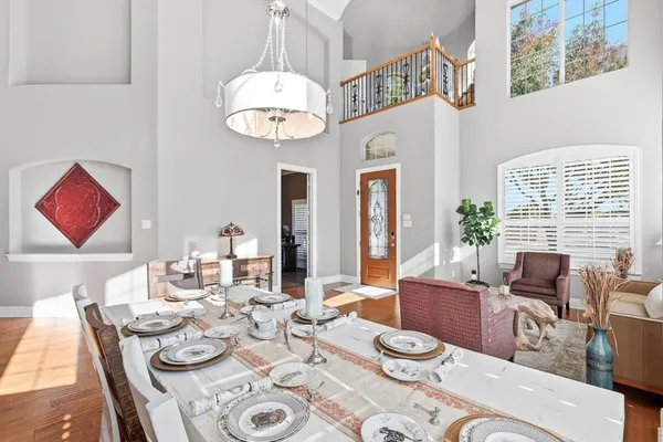 a view of a dining room with furniture wooden floor and chandelier