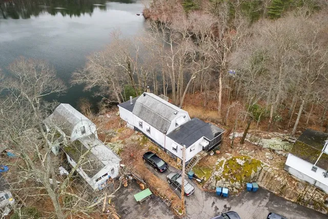 an aerial view of a house with ocean view