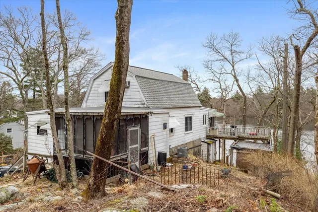 a view of a house with wooden fence