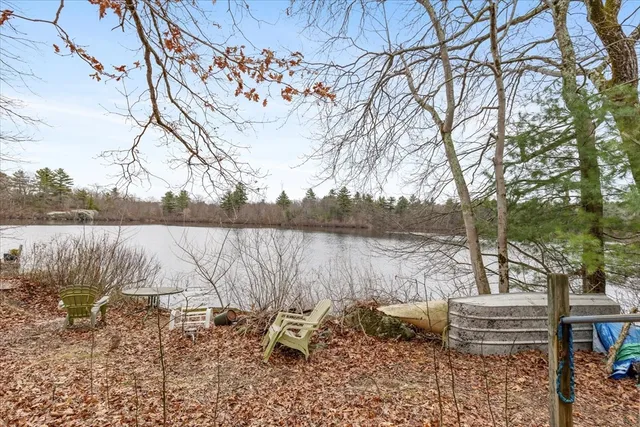 a view of lake with table and chairs
