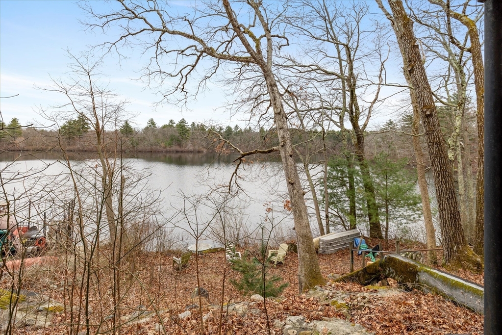 30 Manitou Road Canton, MA 02021 - Photo 9 of 25 a view of a lake with a bench and trees