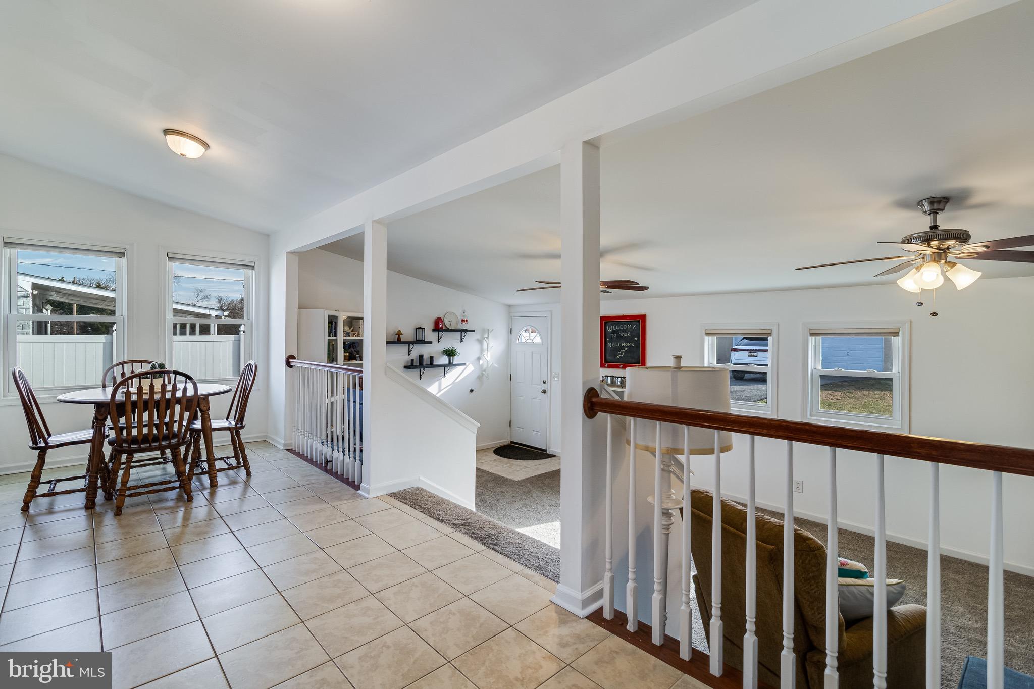 6905 East Clinton Street Clinton, MD 20735 - Photo 16 of 47 a living room with furniture and a dining table