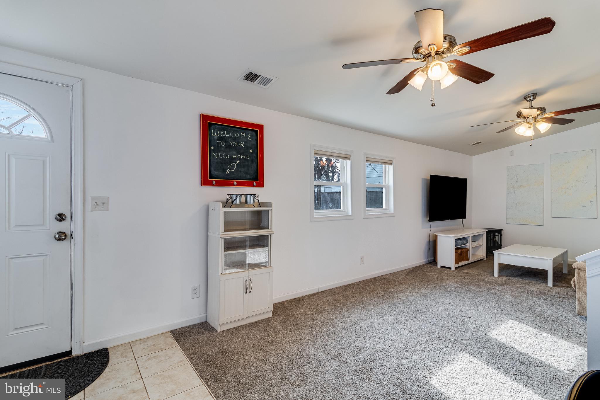 6905 East Clinton Street Clinton, MD 20735 - Photo 19 of 47 a living room with furniture and a flat screen tv