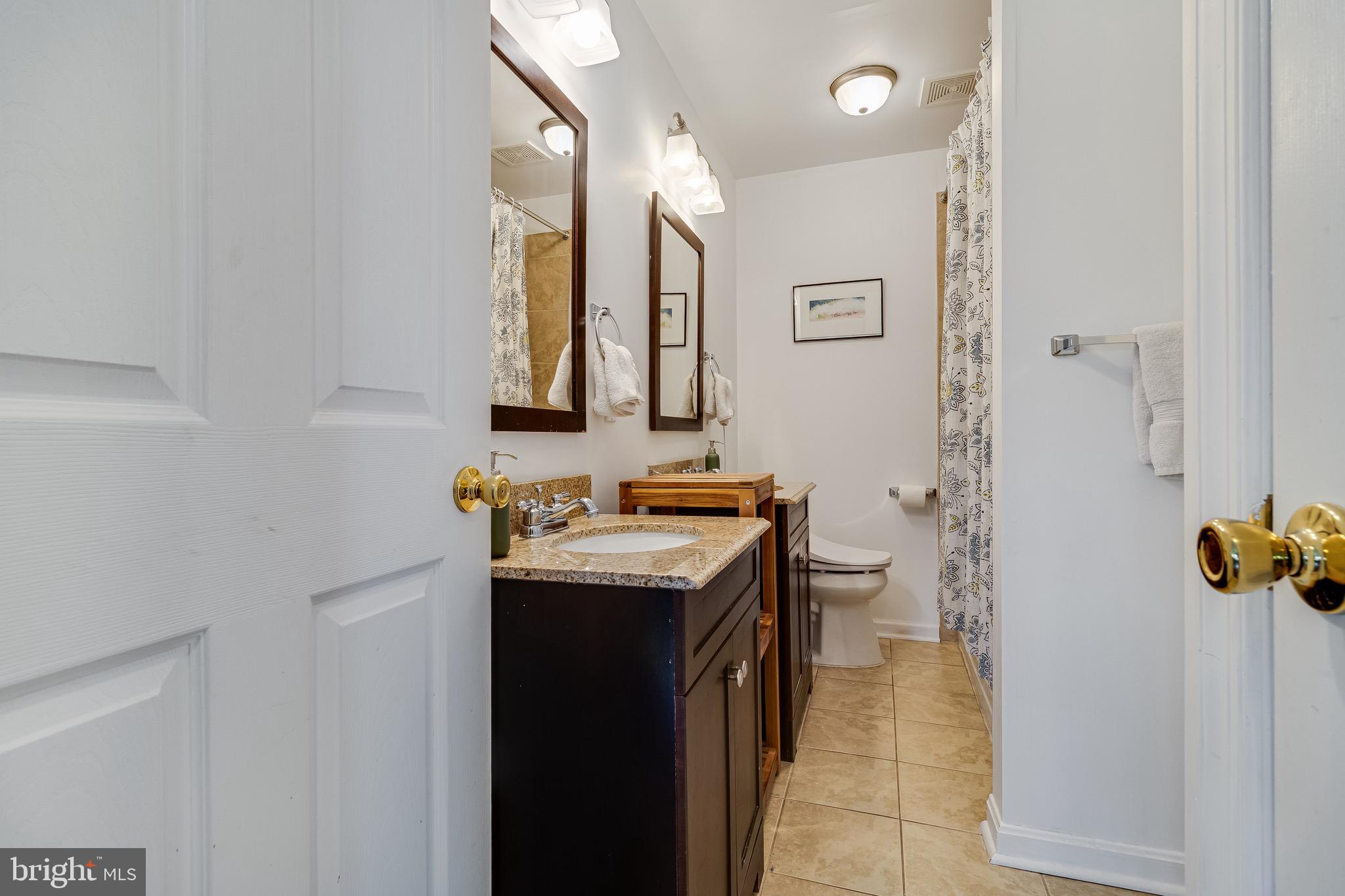 6905 East Clinton Street Clinton, MD 20735 - Photo 28 of 47 a bathroom with a sink toilet and mirror