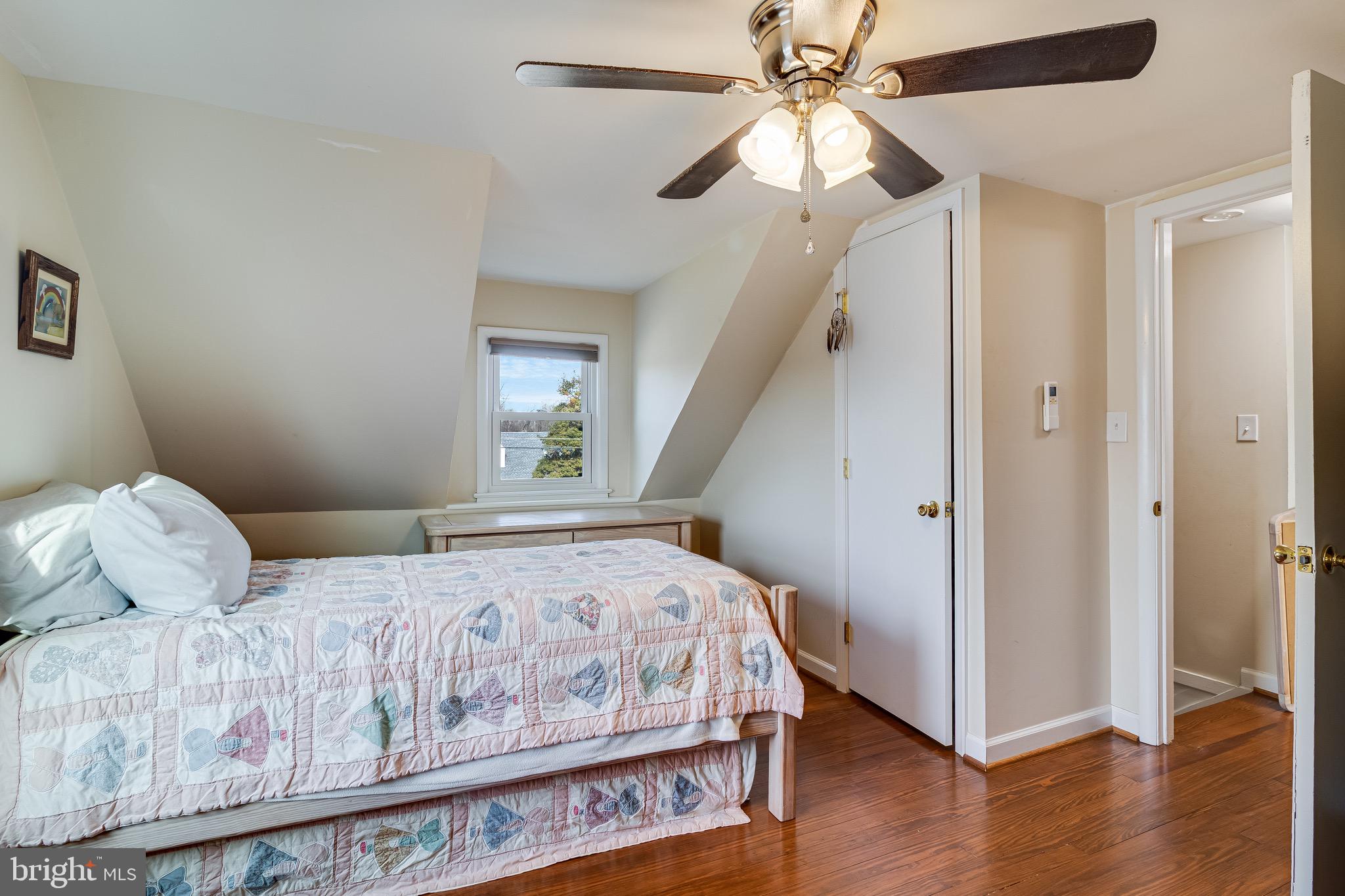 6905 East Clinton Street Clinton, MD 20735 - Photo 30 of 47 a bedroom with a bed and wooden floor