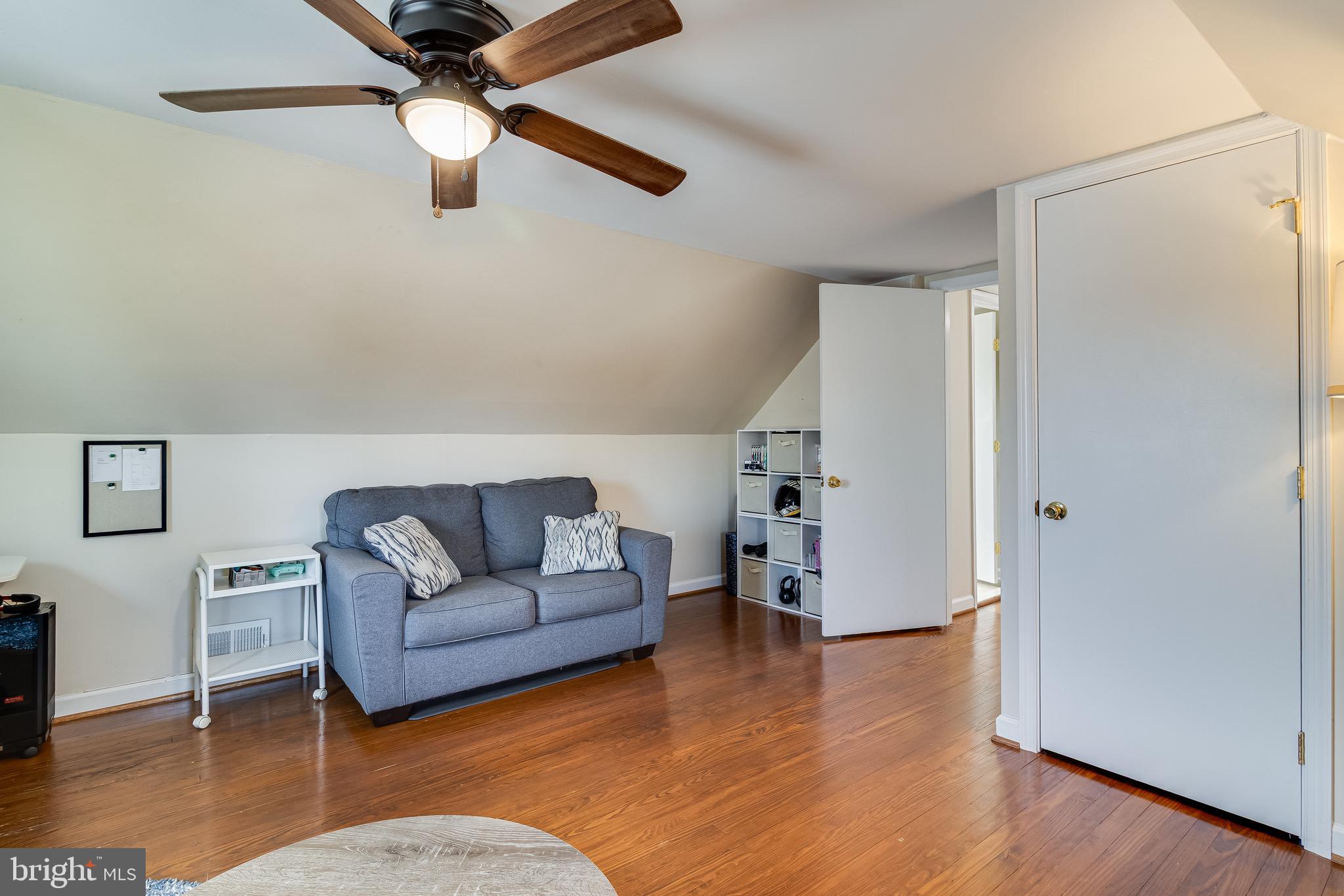 6905 East Clinton Street Clinton, MD 20735 - Photo 35 of 47 a living room with furniture and a wooden floor