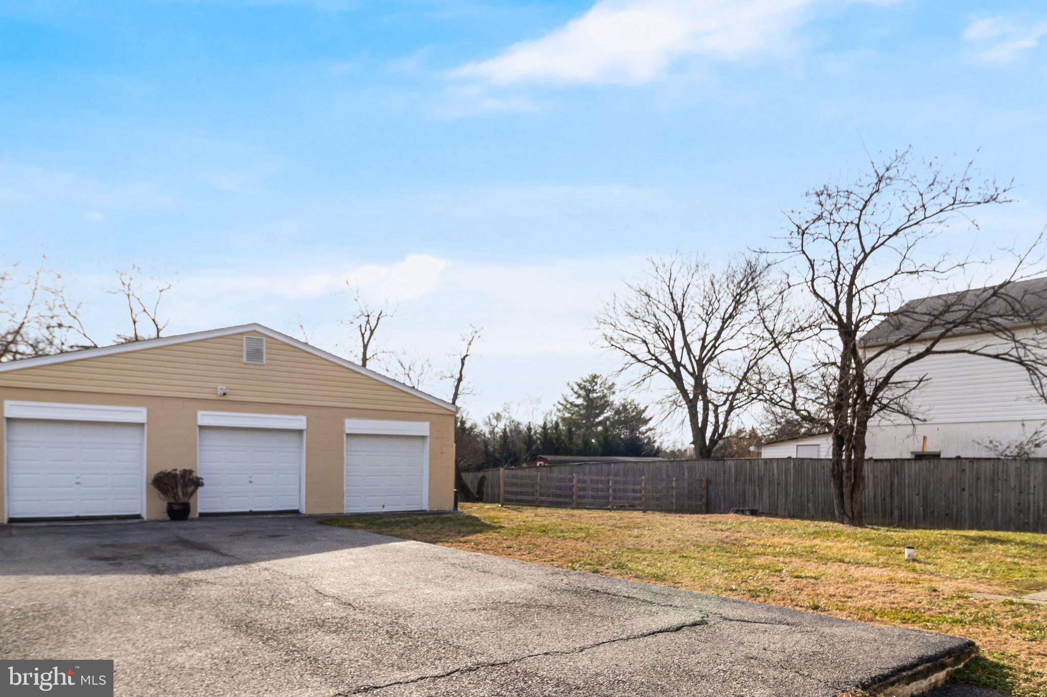 6905 East Clinton Street Clinton, MD 20735 - Photo 45 of 47 a front view of a house with a yard and garage