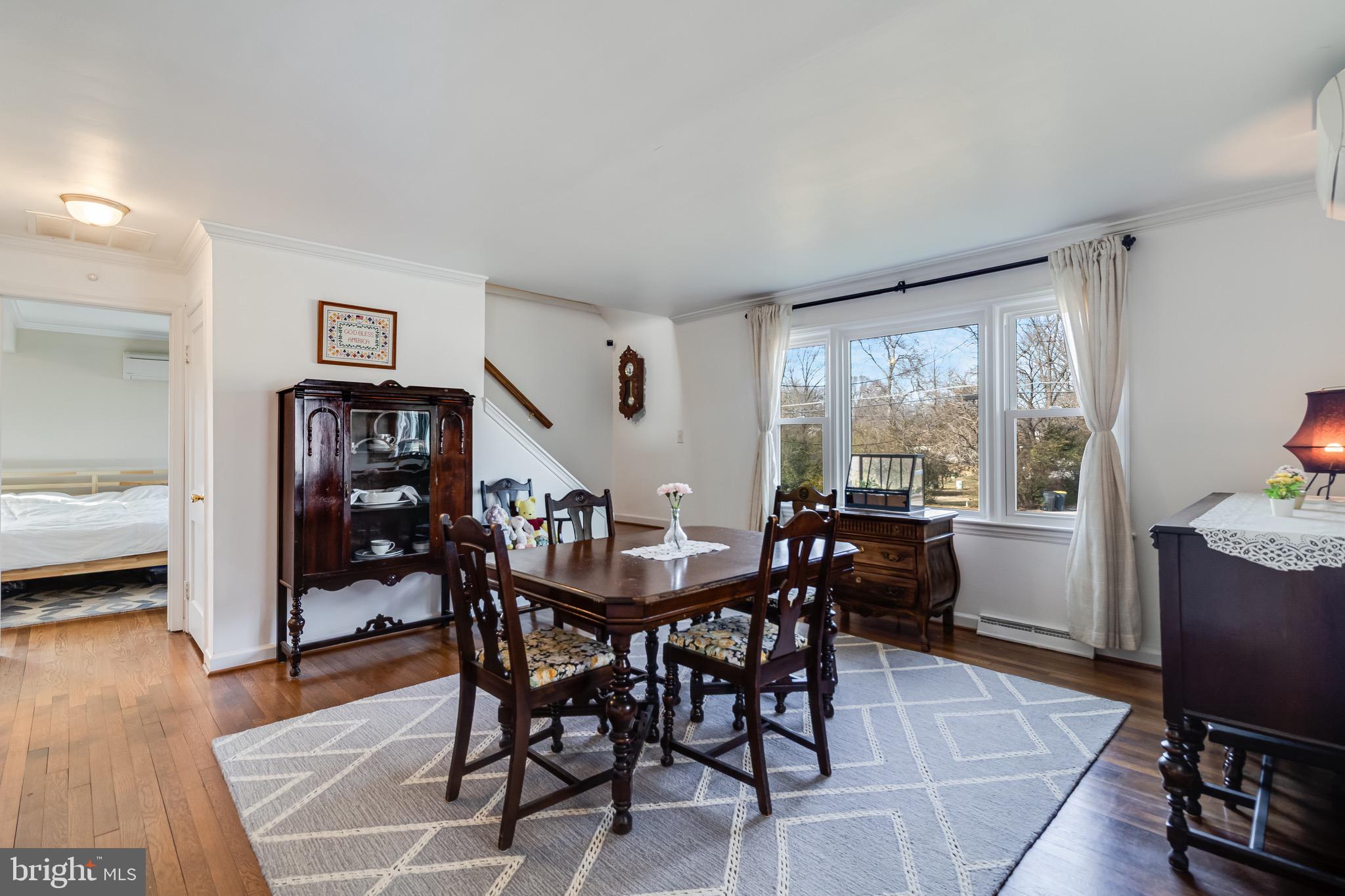 6905 East Clinton Street Clinton, MD 20735 - Photo 6 of 47 a view of a dining room with furniture and wooden floor