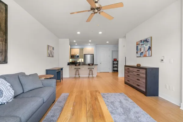 a living room with furniture and kitchen view