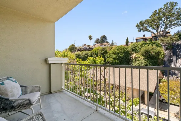 a balcony with a bench in front of it