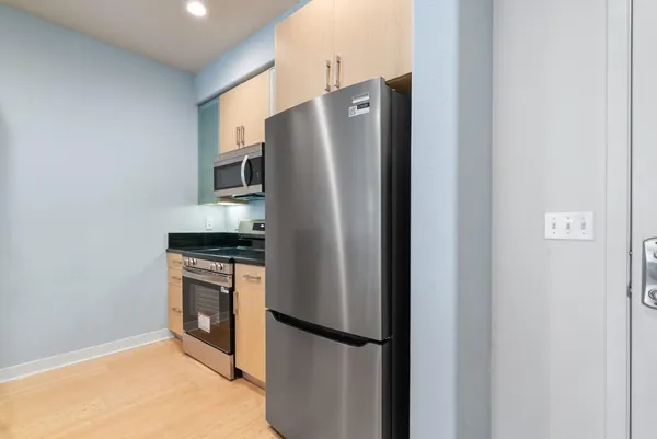 a metallic refrigerator freezer sitting in a kitchen