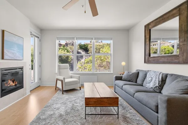 a living room with furniture and a fireplace
