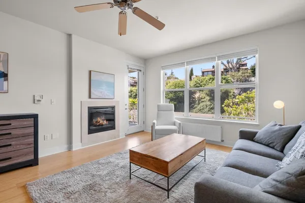 a living room with furniture and a fireplace