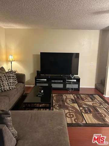a white kitchen with granite countertop stainless steel appliances stove and sink