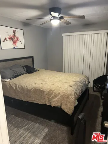 a bedroom with a bed and a walk in closet