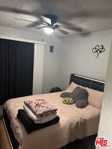 a bathroom with a granite countertop toilet sink and mirror
