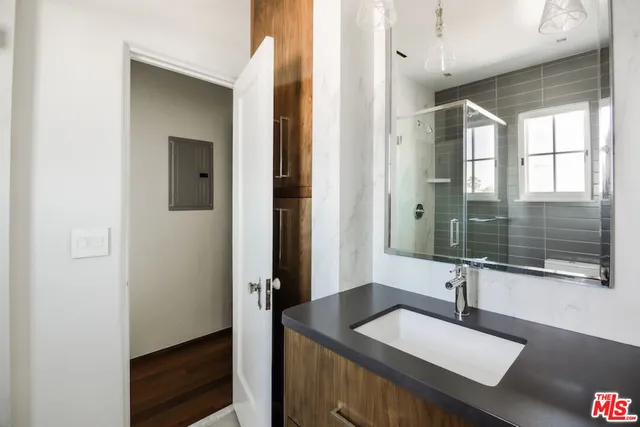a bathroom with a granite countertop sink mirror and double