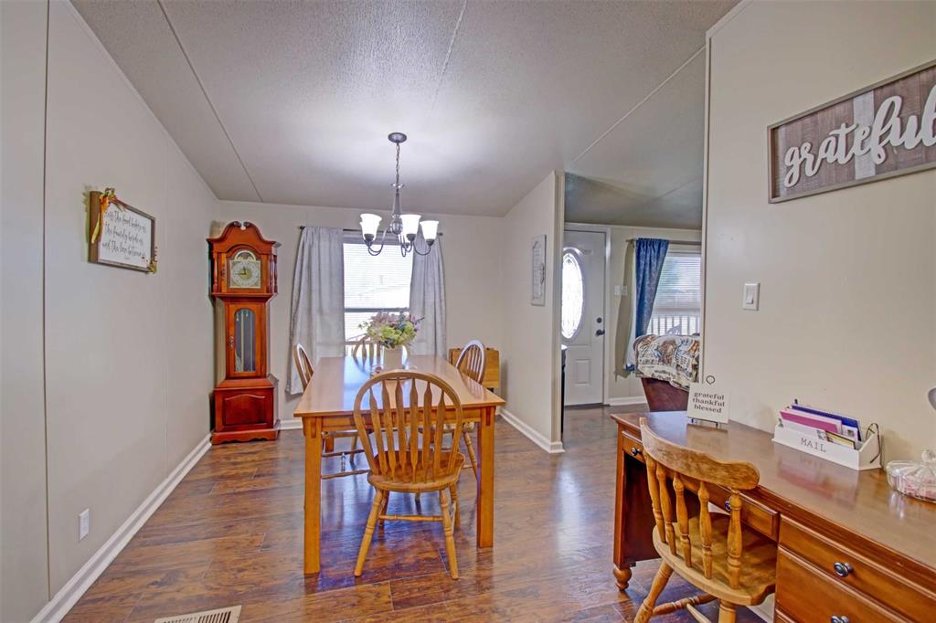 2004 Fall Creek Road Cleburne, TX 76033 - Photo 5 of 18 a view of a dining room with furniture and chandelier