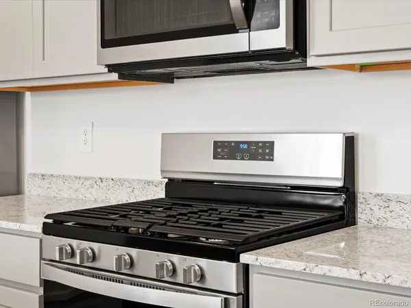 a stove top oven sitting inside of a kitchen