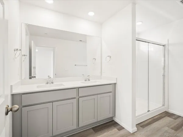 a bathroom with a double vanity sink and mirror