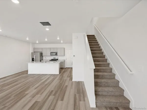 a view of kitchen with cabinets and wooden floor